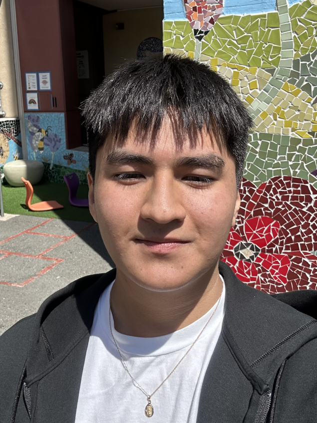 smiling man with short black hair