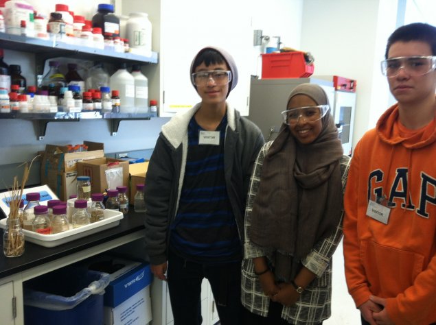 Three students visit a research lab. 