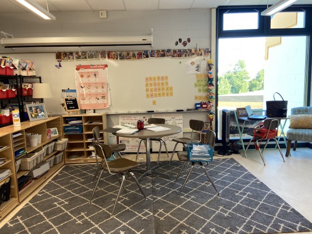 ARTIF small group station including a desk, whiteboard, and vowel chart, and letter cards