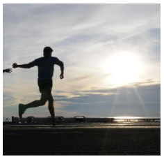 Man running with th sun setting near the water