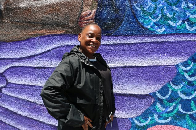 Jeanine Kennard in front of colorful mural