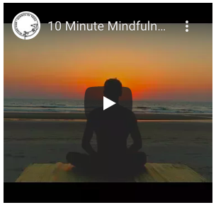 Text reads "10 Minute Mindfulnes..." with play button icon and a person sitting down at the beach facing the sunset