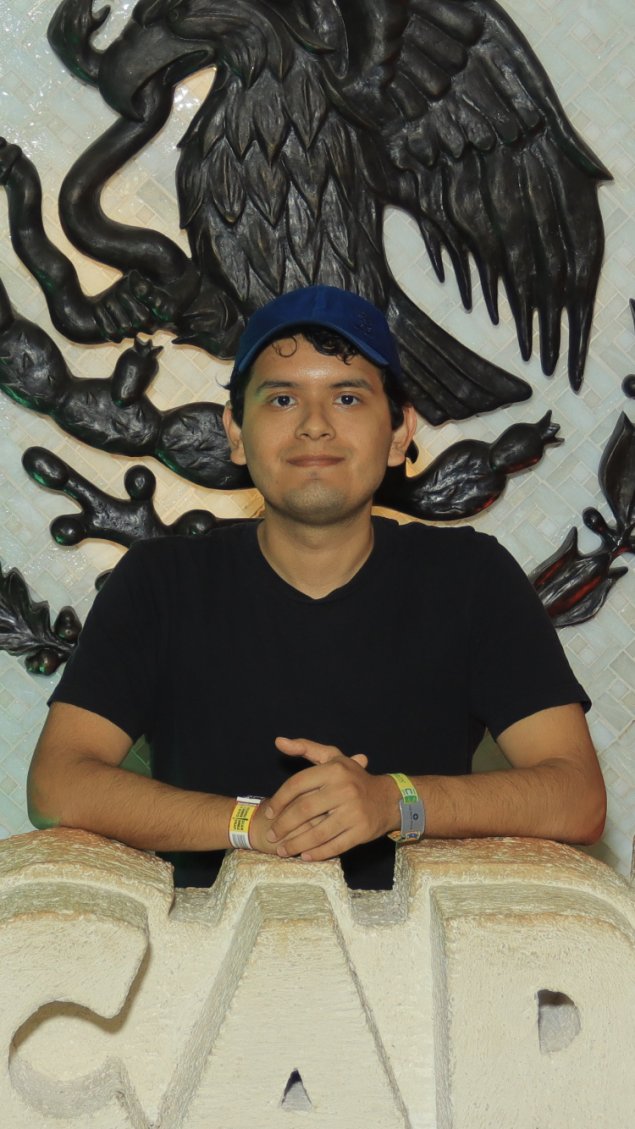 Miguelangel smiling in front of artwork
